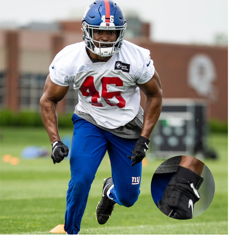 Justin Hilliard at Giants practice, wearing a WHOOP strap on his left wrist